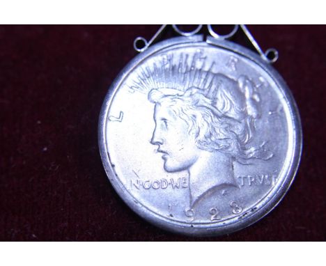A 1923 American silver dollar in a stirling silver mount 
