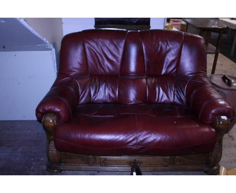 A vintage red leather two seater sofa.  Postage unavailable 