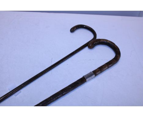 Two antique walking canes. One with a hallmarked silver collar. . Postage unavailable 