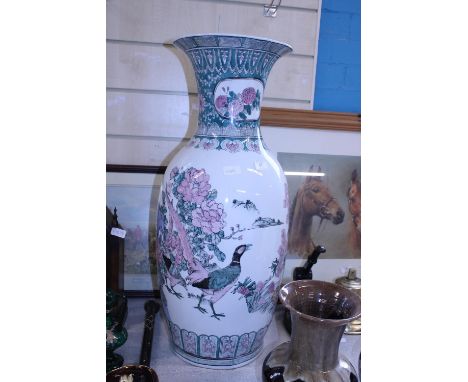 A large Oriental ceramic vase (small crack to rim).  Postage unavailable 