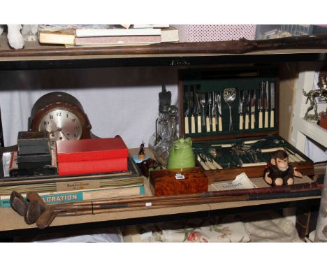 Large mantel clock, canteen of cutlery, vintage gold clubs, vintage games, glass decanter and ewer, music box, ornaments, etc