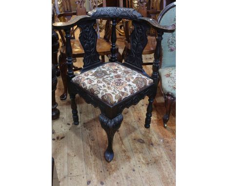 19th Century carved corner elbow chair with floral tapestry seat.
