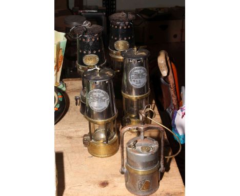 Pair of Patterson and pair of Protector Lamp and Lighting Co. miners lamps and another lamp.