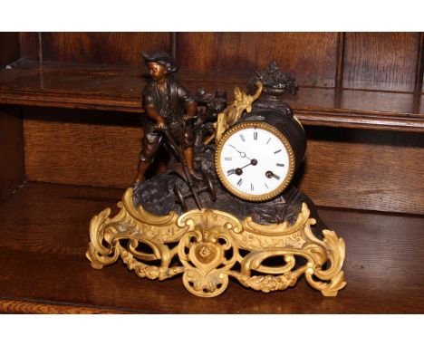 Ornate gilt mantel clock depicting a working young boy, 28cm high.