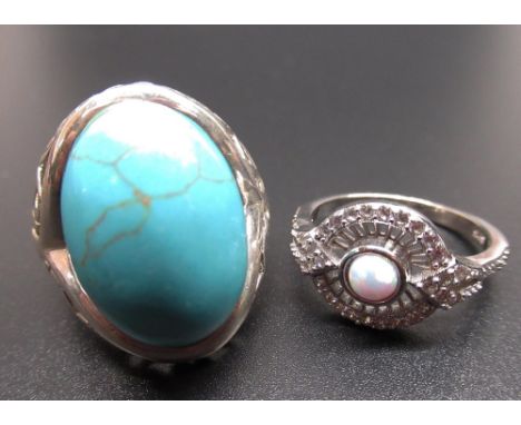 Sterling silver ring set with cabochon turquoise, size P, stamped 925, and a Sterling silver circular ring set with a central