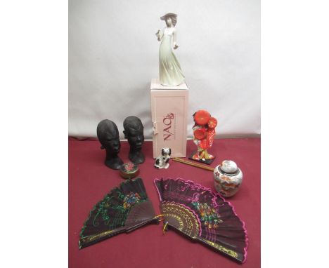 Nao figure of a lady with a flower with original box, Geisha doll, 2 African tribal art heads from Nigeria, a oriental lidded