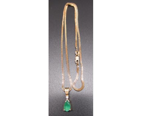 18ct yellow gold pendant set with pear cut emerald and brilliant cut diamond, on 18ct yellow gold snake chain with lobster cl