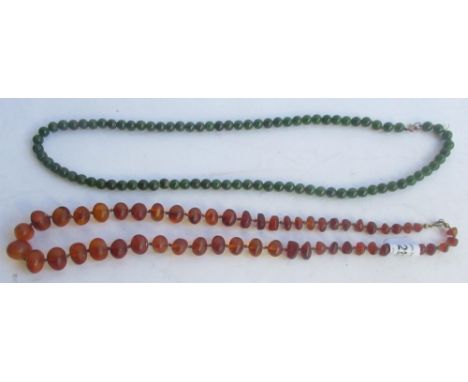 Syd Little Collection - Early C20th graduating amber bead necklace with hand knotted string and a green hardstone jade style 