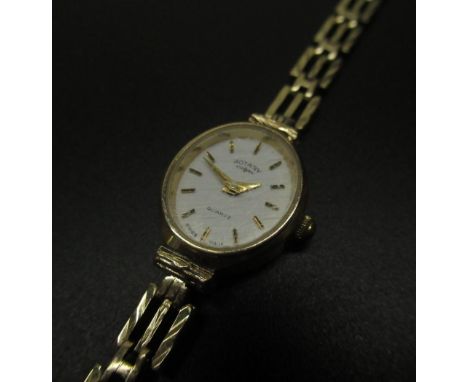 Ladies rotary 9ct gold quartz cocktail watch, signed white dial with applied gold coloured stick hour markers, oval case on g