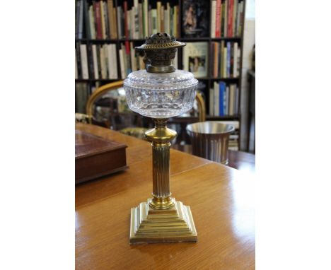 A Victorian brass fluted oil lamp with cut clear glass reervoir, raised on stepped square base, 48cm high 