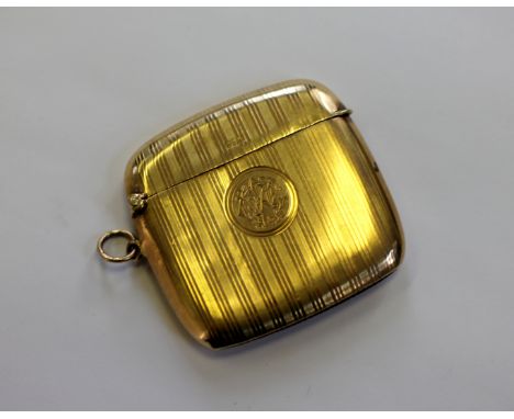 A 9ct yellow gold vesta case Horace Woodward & Co Ltd, Birmingham 1910, of cushion shape and with engine turned stripe decora