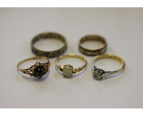 A collection of five gold rings, to include; an opal set ring in yellow metal, stamped '750 18k', weight 1.8gms, a cz set sol