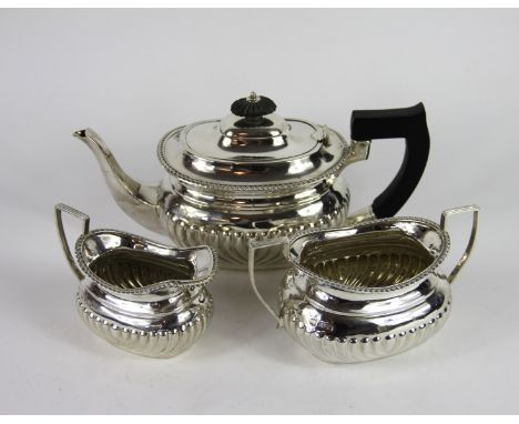 A silver three piece batchelor's tea service, William Padley & Son Sheffield 1900, each of half reeded form, the teapot with 