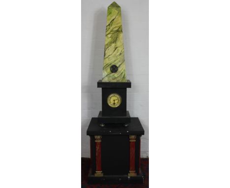 An Empire style obelisk mantel clock, with eight day movement and Arabic dial, on ebonised base, 150cm