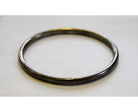 A silver slave bangle, Charles Horner Chester circa 1910, of plain polished form, 8.6cm diameter, weight 10.8gms