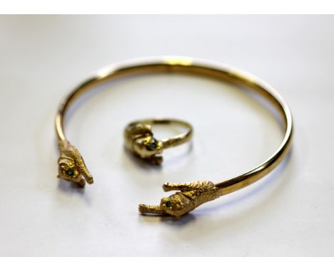 A 9ct yellow gold bangle, Birmingham 1988, the plain bangle with two panther terminals, weight 5.8gms and a matching ring wit