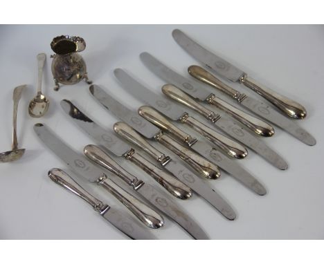 A set of six table knives and six side knives, a silver fiddle pattern ladle, Andrew Wilkie Edinburgh 1826, a silver cream ju