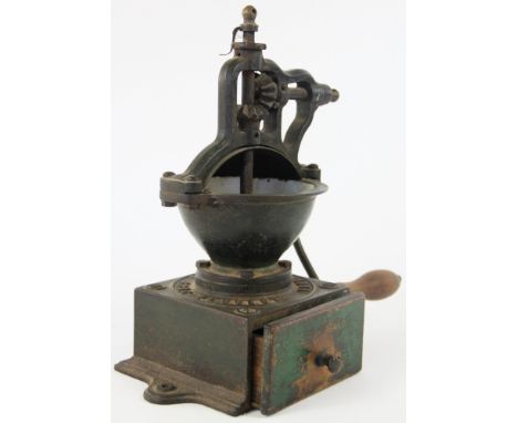 A late 19th century French cast iron coffee grinder by Peugeot Freres, A1 model with brass cover and finial, 35cm
