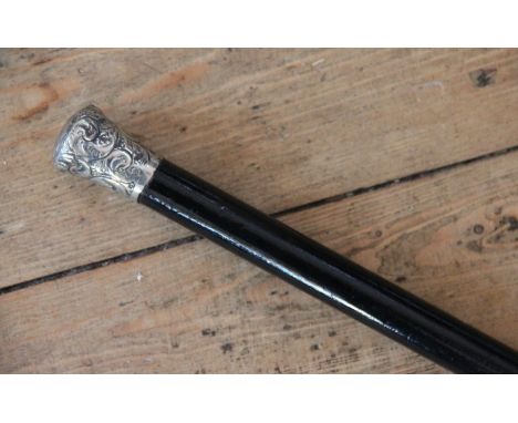 A Royal Flying Corps swagger stick, with white metal mount embossed with RFC insignia and ebonised shaft, 89cm