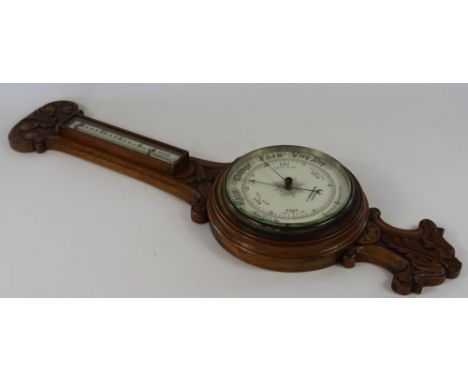 A Victorian carved oak aneroid barometer, with thermometer above a ceramic dial signed C. Tidemann, Liverpool, 86cm