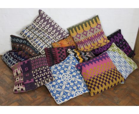 A collection of fourteen cushions with knitted wool or tapestry covers, and another with Liberty style fabric; with a prayer 