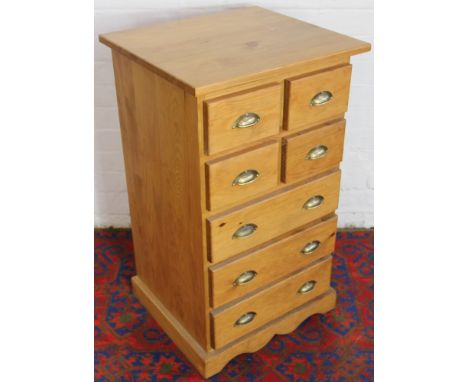 A modern pine bank of four short and three long drawers on bracket feet, 90 x 53 x 47.5cm