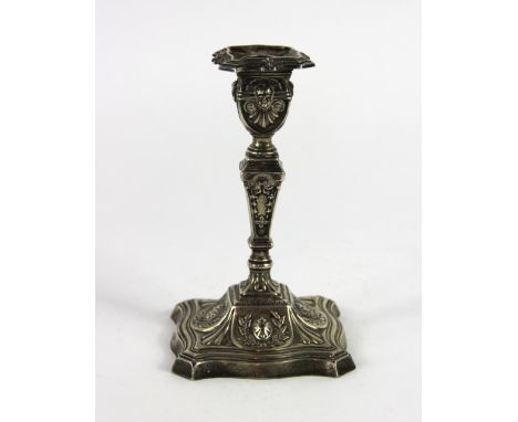 A silver candlestick Cooper Brothers, Sheffield 1897, of typical baluster form with embossed Adam style decoration and raised