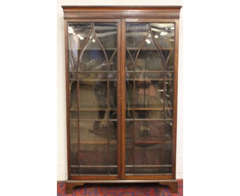 A mahogany bookcase, with astragal glazed doors on bracket feet, 176.5 x 108 x 29cm