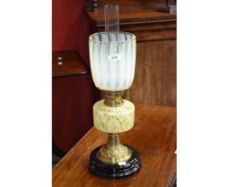 A Victorian green vaseline glass and brass table oil lamp, fluted shade, marbled reservoir, black ceramic base, 55cm high, c.