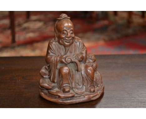A Chinese bamboo carving, of a scholar, seated, holding a scroll, a young boy at his side, 15.5cm high, 19th century