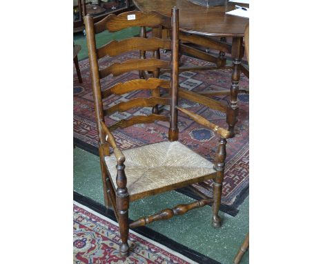 A 19th century rush seated ladder back armchair