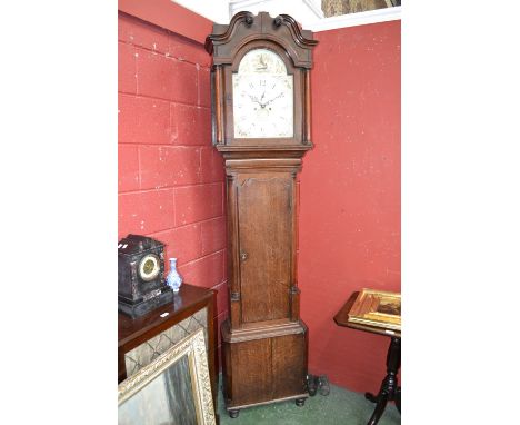 A Regency oak and mahognany inlaid longcase clock, curly pediment to hood, supported on turned columns, painted 13in (33cm) b