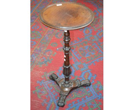 A George IV rosewood tripod wine table, dished circular top, turned and carved lotus grasped column, triform base, lotus scro