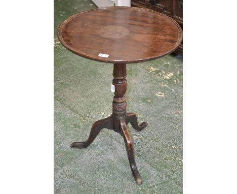 A George III mahogany tilt top tripod table, dished circular top, turned column, cabriole legs, pad feet, 70cm high, 54cm dia