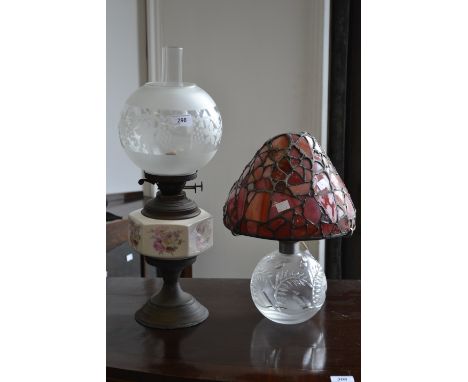 A Victorian oil lamp decorated with panels of roses;  a large domed light with cut glass base (2)