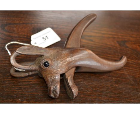 A Black Forest novelty nut cracker, carved as a deer, glass eyes, 17.5cm long, c.1920 