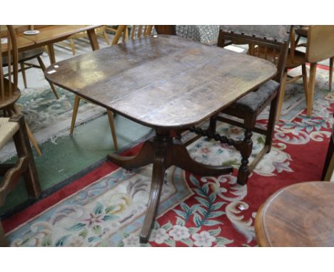 An early 19th century oak tripod breakfast table