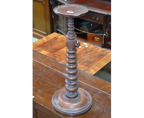 A Victorian mahogany adjustable floor standing candle stand, dished circular top, graduated ring-turned column, domed circula
