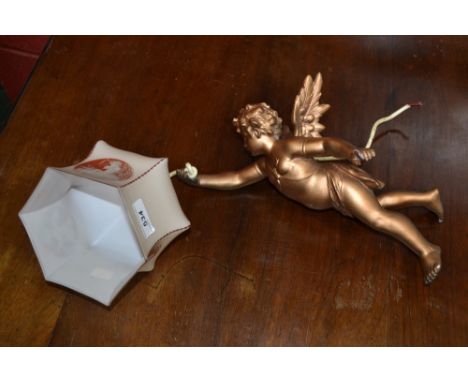 A gilt cherub ceiling light with cherub playing flute decorated shade