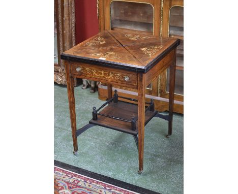 A late Victorian rosewood and marquetry rounded square envelope card table, the quadripartite folding top enclosing an inset 