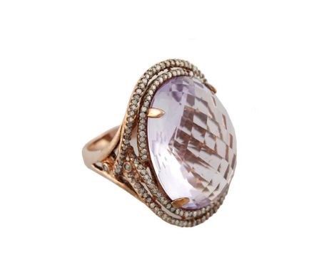 A LARGE OVAL SHAPED FACETED AMETHYST DRESS RING, to a double round cut diamond surround, within a 9 carat rose gold setting