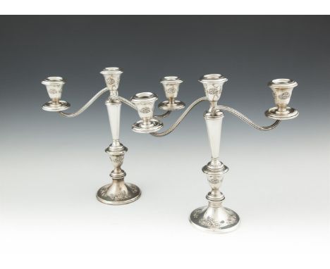 A PAIR OF SILVER THREE LIGHT CANDLEABRA, by Gorham & Co., stamped 'STERLING', the sconces decorated with floral sprays, raise