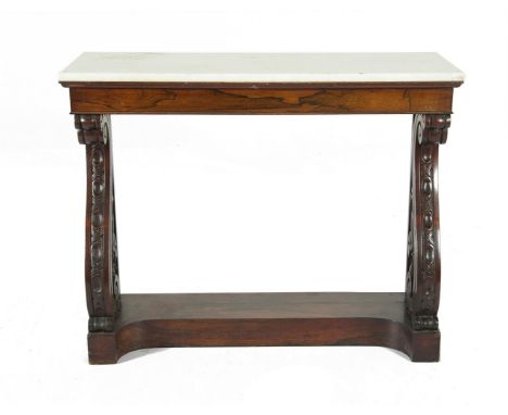 A VICTORIAN ROSEWOOD RECTANGULAR CONSOLE TABLE, the white marble top raised above a plain frieze, on twin carved scroll end s