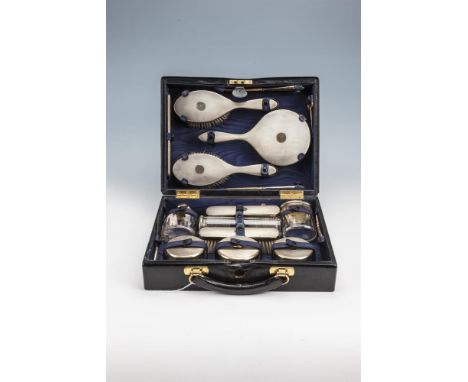 A SILVER TRAVELLING TOILETTE SET, London 1937, contained in a black leather case, comprising hand mirror, pair of hair brushe