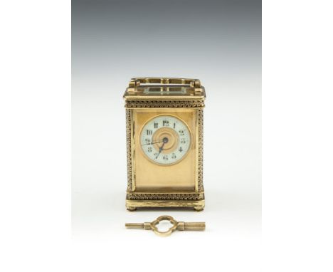 AN EDWARDIAN BRASS CASED CARRIAGE CLOCK, with enamel dial, complete with key