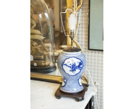 A CHINESE BLUE AND WHITE PORCELAIN TABLE LAMP, 19th century, converted to electricity, the baluster shaped body, decorated wi