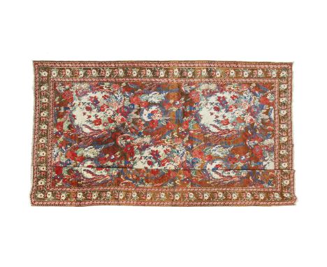 A LARGE KARABAGH WOOL CARPET, with central field of foliage in off-white, rust, blues and reds within multiple borders and gu