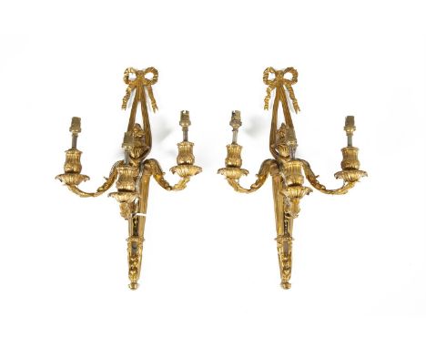 A PAIR OF 19TH CENTURY ORMOLU THREE BRANCH WALL LIGHTS, suspended from a ribbon tie and decorated with centre torchere and wi