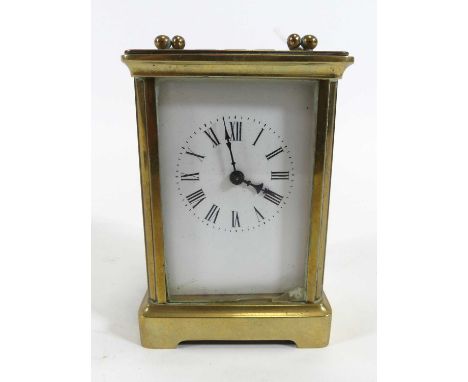 A brass carriage clock, the enamel dial showing Roman numerals, having visible platform escapement, height 11cm