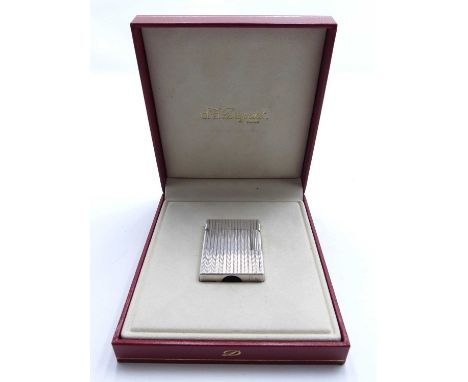 An SJ Dupont cigarette lighter of rectangular shape, having engine turned decoration, height 4.5cm, in gilt embossed red leat